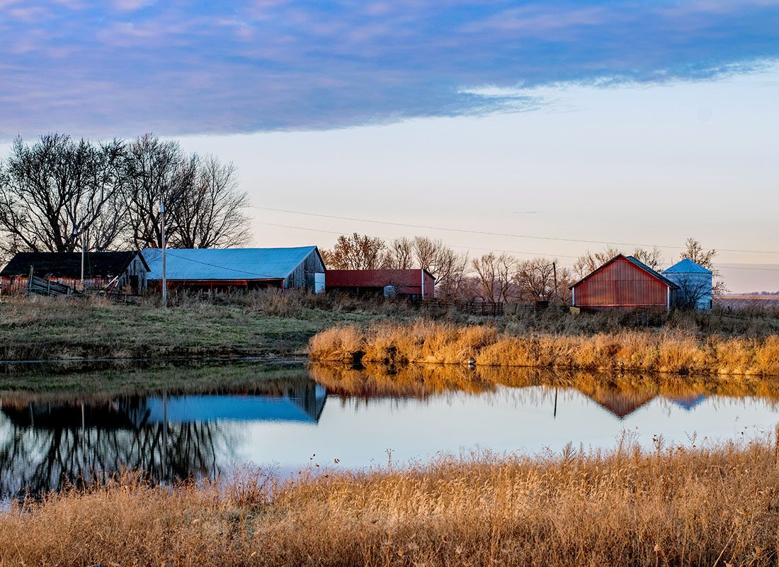 Newton, IA - Scenic View of Farm Buildings Next to a Pond in Newton Iowa on a Sunny Fall Day